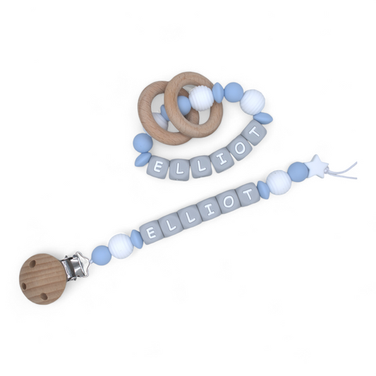 Pacifier clip for babies featuring baby blue and white silicone beads. A matching silicone rattle ring is in the picture.